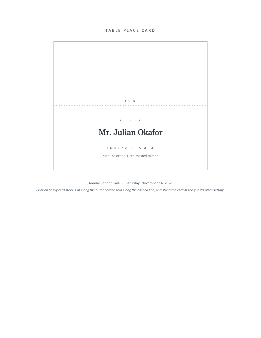 Rendered place card sheet: a tall card outline with a dashed fold line, the guest name in serif type, table and seat numbers, a menu selection line, and the event name and date at the base of the card